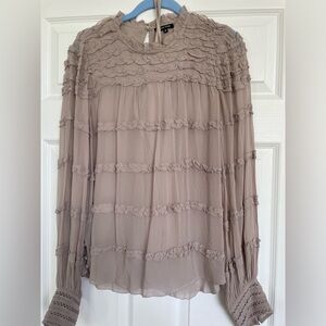 Size medium women’s blouse with button and ruffle detail.  Includes under shirt
